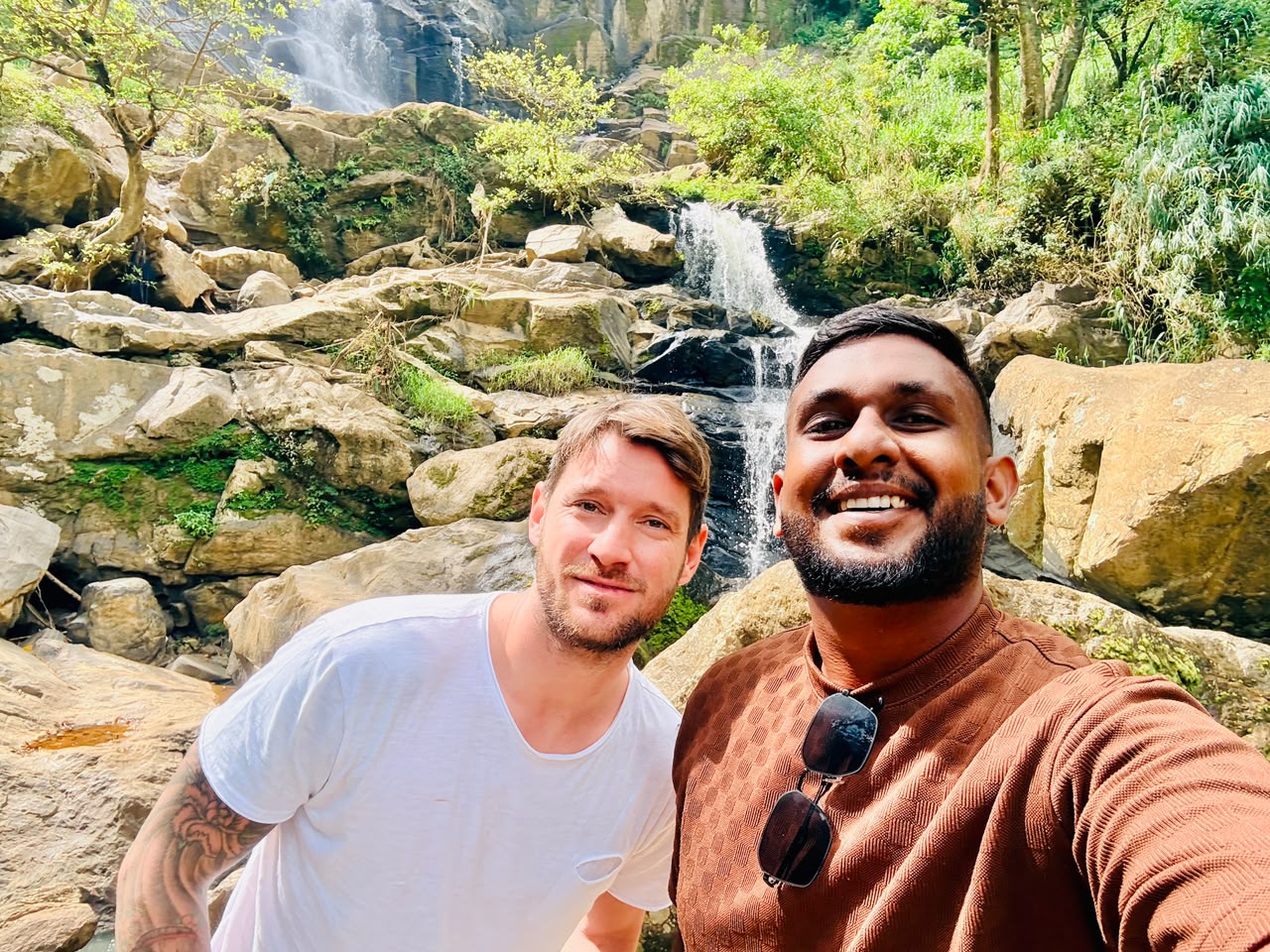 Travellers visiting a waterfall during a Sri Lanka hill country tour